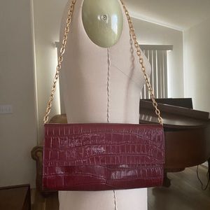 Bloomingdales burgundy purse with chain handle.